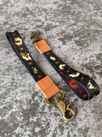 Load image into Gallery viewer, Gold Skulls and Flowers Wrist Lanyard
